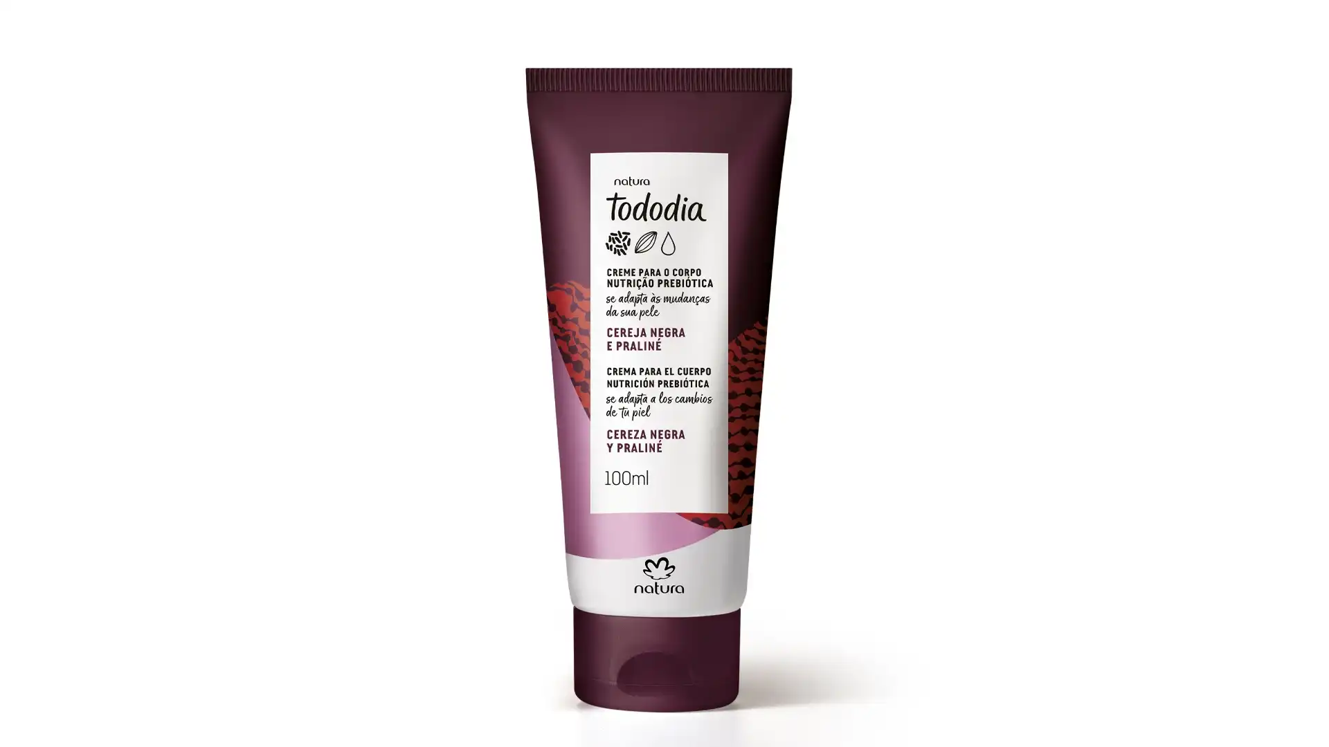 Um tubo de creme hidratante corporal Natura Tododia na cor bordô com rótulo branco. O rótulo mostra os dizeres “Creme para o corpo nutrição prebiótica se adapta às mudanças da sua pele” em português e espanhol.