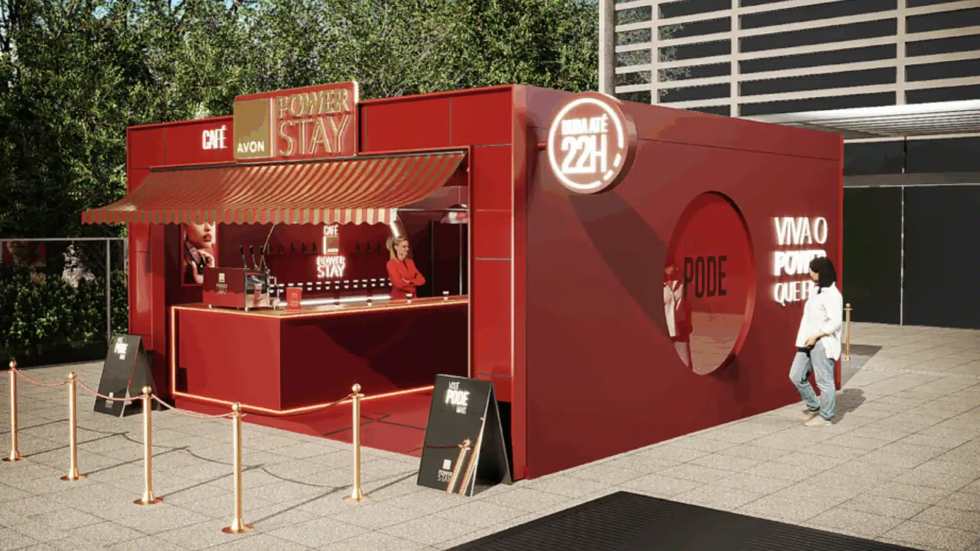 Quiosque pop-up da AVON Power Stay em vermelho, estilizado como um café, com balcão de atendimento, toldo e sinalização externa (DURA ATÉ 24H).